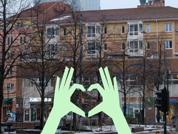 Bilde av Grønland torg, med illustrasjon av to hender som former et hjerte rundt t-bane skiltet Grønland.